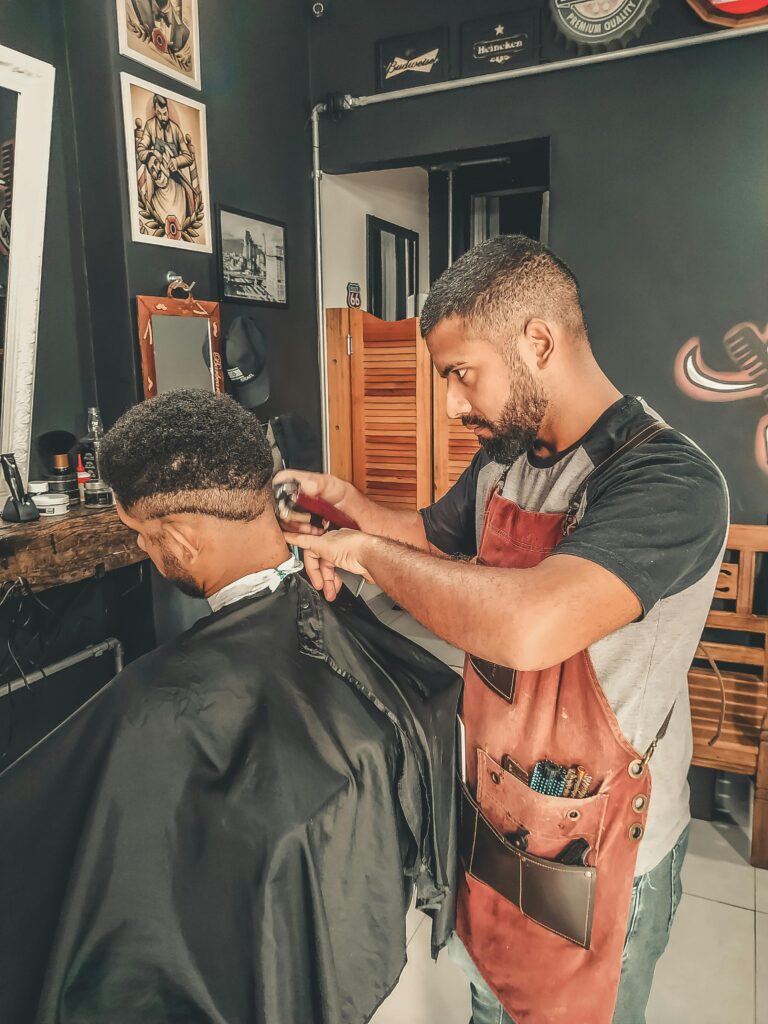Experienced barber styling hair in a modern barbershop setting.